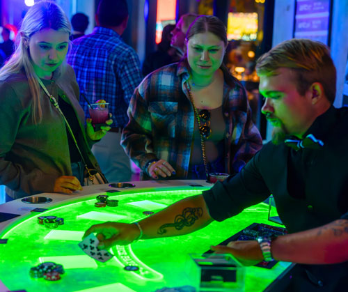 dealing cards at a neon green black jack table