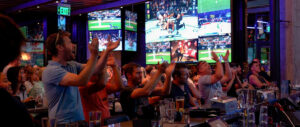 Fans cheering at the bar