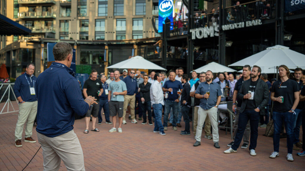 Outdoor Event Speaker at Tom’s Watch Bar A speaker addresses a crowd during an outdoor event outside Tom’s Watch Bar.