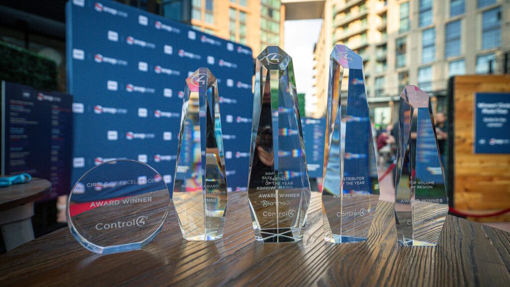 Control4 Awards Display Crystal Control4 award trophies displayed on a table at an outdoor event.