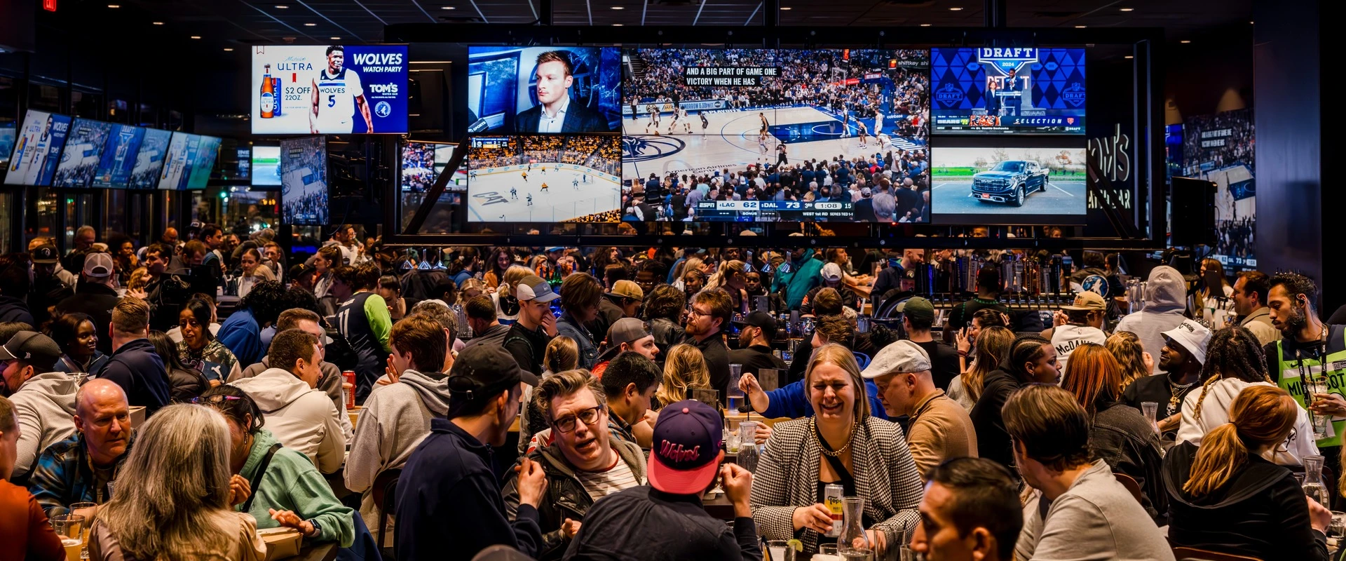 Packed crowd watching the Timberwolves playoffs on the screen wall at Tom's Watch Bar Minneapolis – Target Center